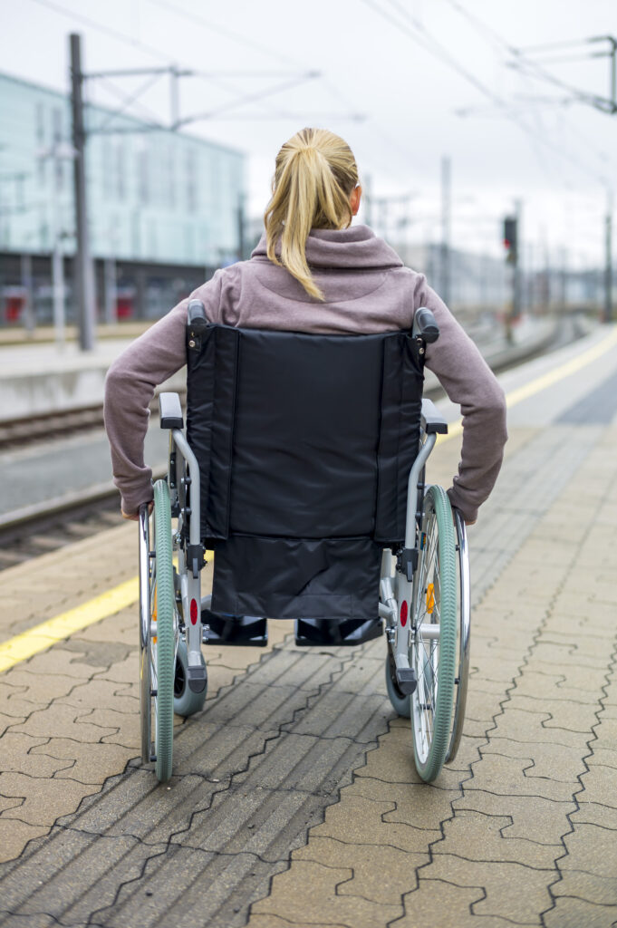 Frau im Rollstuhl am Bahnsteig